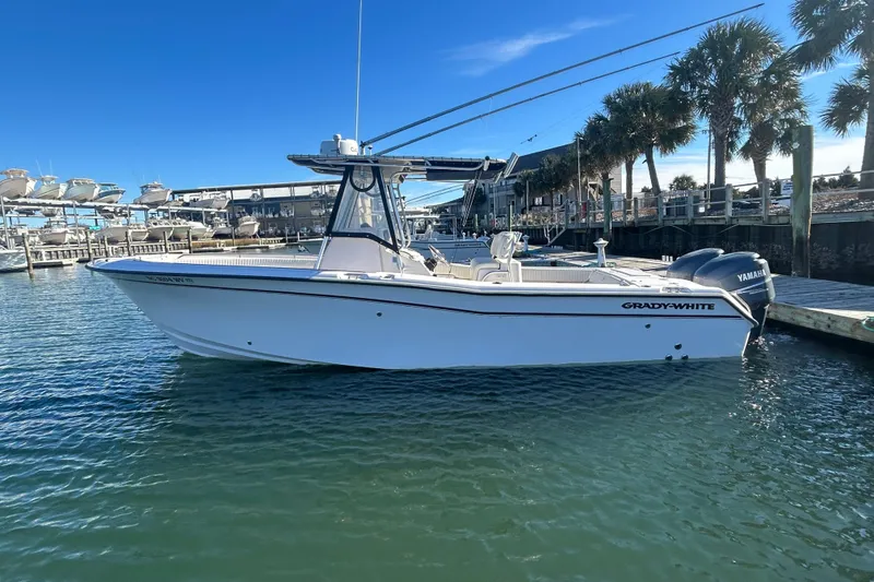 The Image of 2003 Grady-White Chase 273 boat docked in marina, clear blue sky background. - 1
