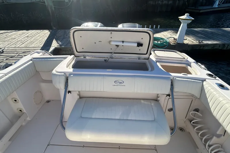 Slide: The Image of 2003 Grady-White Chase 273 boat interior with open storage compartment at dock. - 10