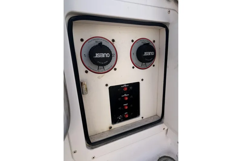 Slide: The Image of Control panel of a 2003 Grady-White Chase 273 boat with battery switches. - 12