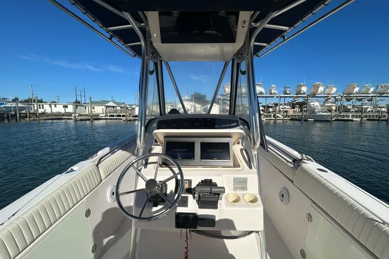 Slide: The Image of 2003 Grady-White Chase 273 boat helm with Garmin navigation, docked at marina. - 16
