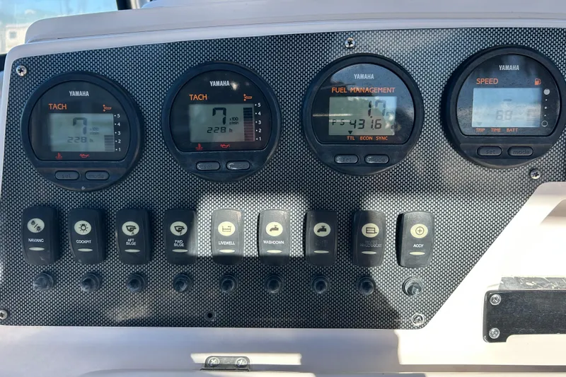 Slide: The Image of Dashboard of a 2003 Grady-White Chase 273 boat with Yamaha gauges and switches. - 18