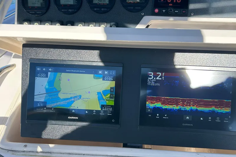 Slide: The Image of Garmin navigation and sonar displays on 2003 Grady-White Chase 273 boat dashboard. - 19