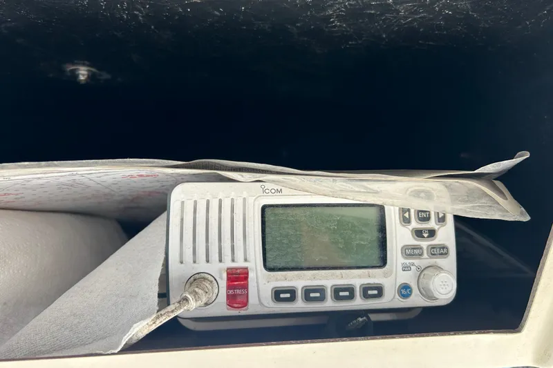 Slide: The Image of VHF radio on 2003 Grady-White Chase 273 boat, partially covered by papers. - 20