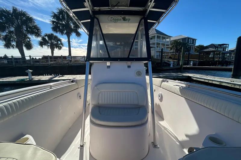Slide: The Image of 2003 Grady-White Chase 273 boat interior with seating, docked under clear blue sky. - 23