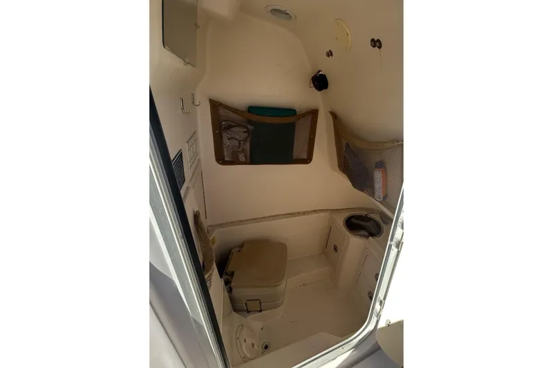 Slide: The Image of 2003 Grady-White Chase 273 boat interior with storage and compact amenities. - 25