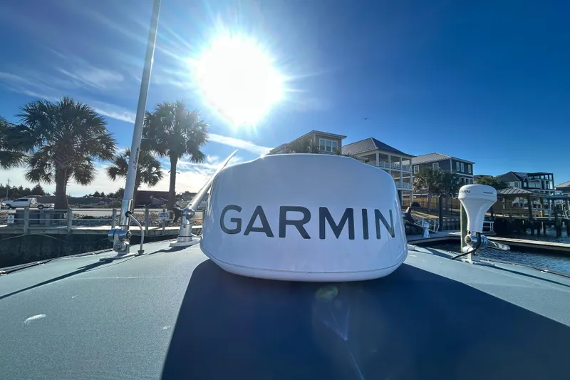 Slide: The Image of 2003 Grady-White Chase 273 boat with Garmin equipment under a bright sunlit sky. - 27