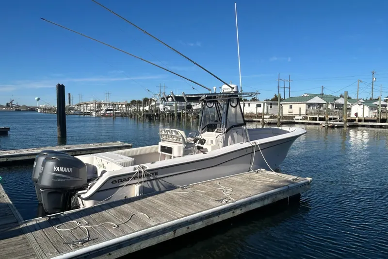 Slide: The Image of 2003 Grady-White Chase 273 boat docked with Yamaha engine, clear blue sky. - 5
