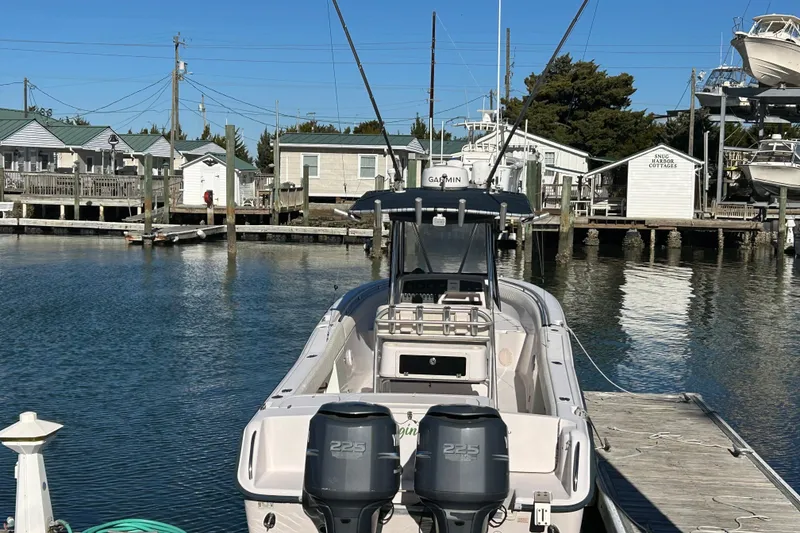 Slide: The Image of 2003 Grady-White Chase 273 boat docked at a marina with clear blue skies. - 7