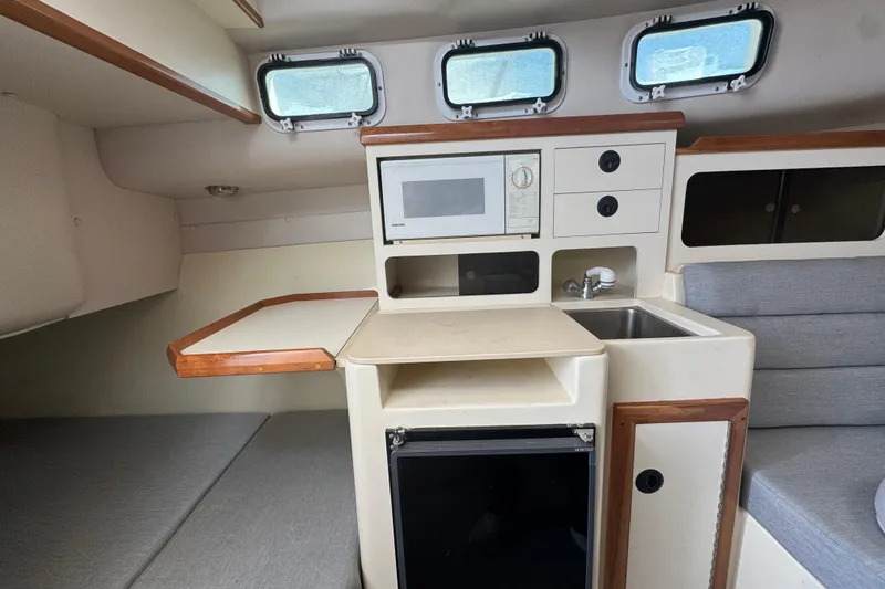 Slide: The Image of Compact kitchen area in 2001 Albin 28 Tournament Express boat with microwave and sink. - 11