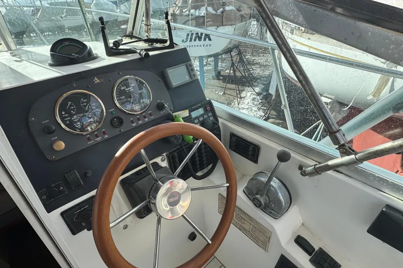 Slide: The Image of 2001 Albin 28 Tournament Express helm with wooden steering wheel and instrument panel. - 7