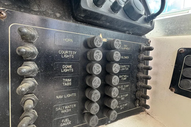 Slide: The Image of Control panel of a 2001 Albin 28 Tournament Express boat with labeled switches. - 9