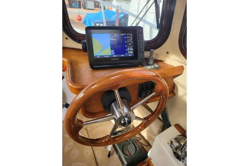 Slide: The Image of 2009 Ranger Tugs R-21 EC helm with Garmin GPS and wooden steering wheel. - 4