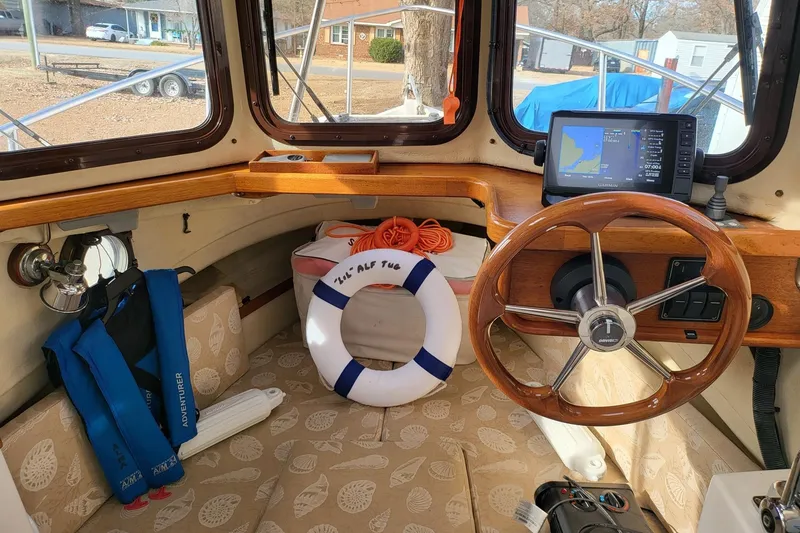Slide: The Image of 2009 Ranger Tugs R-21 EC boat interior with steering wheel, GPS, and life preserver. - 5