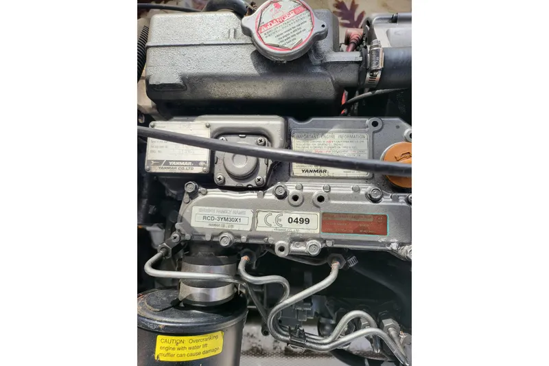 Slide: The Image of Engine of 2009 Ranger Tugs R-21 EC with Yanmar components and caution label. - 7