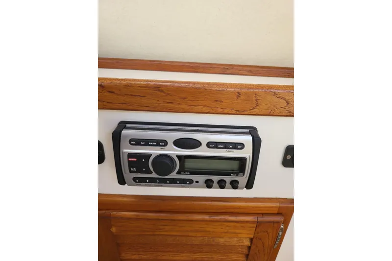 Slide: The Image of 2009 Ranger Tugs R-21 EC radio system with wooden paneling. - 8