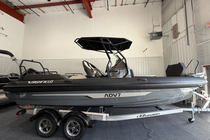 The Image of 2026 Highfield ADV 7 boat on trailer in indoor showroom. - 1