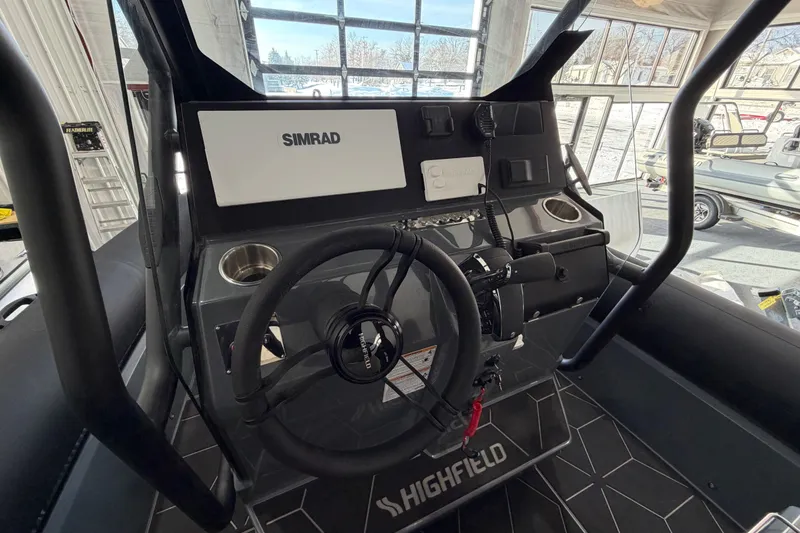 Slide: The Image of 2026 Highfield ADV 7 boat dashboard with Simrad navigation system and steering wheel. - 8