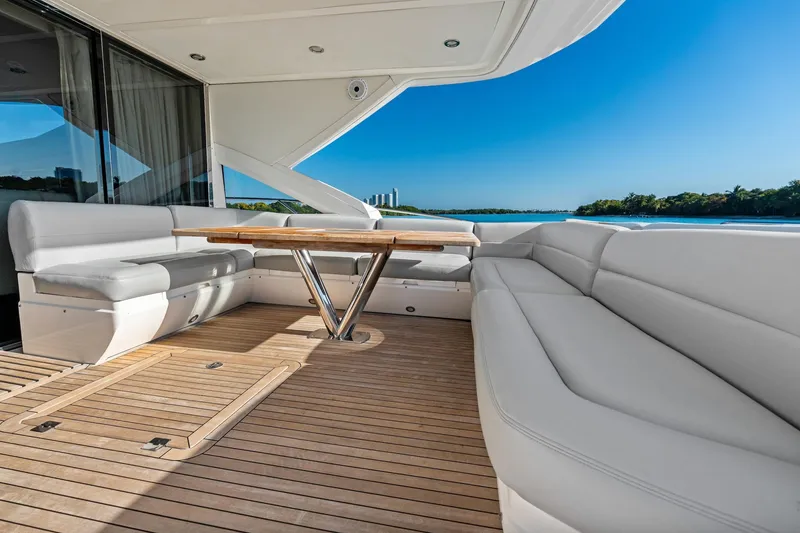Slide: The Image of Luxurious 2014 Sunseeker 68 Sport Yacht deck with seating and table, overlooking serene waters. - 41