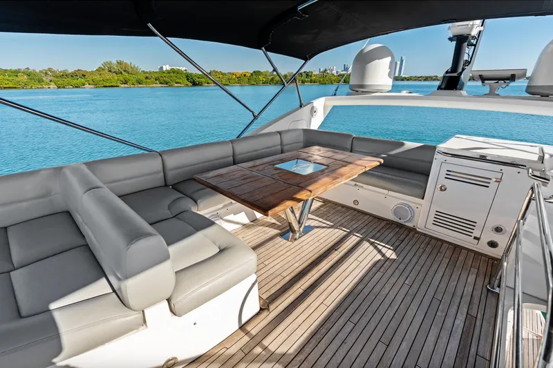 Slide: The Image of 2014 Sunseeker 68 Sport Yacht deck with seating, table, and ocean view. - 44