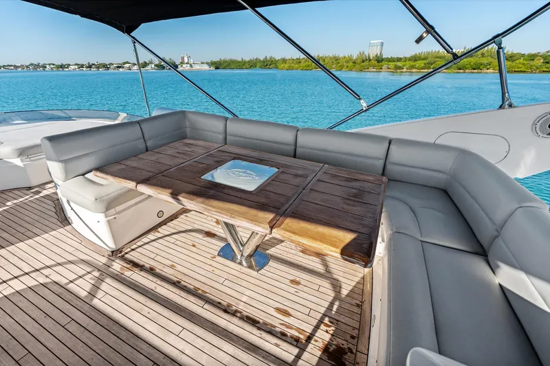 Slide: The Image of Luxurious 2014 Sunseeker 68 Sport Yacht deck with seating, overlooking serene blue waters. - 45