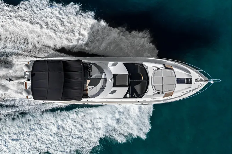 Slide: The Image of Aerial view of 2014 Sunseeker 68 Sport Yacht cruising on clear blue water. - 5