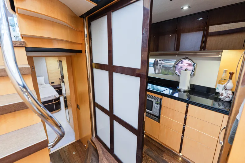 Slide: The Image of Engine room of a 2014 Sunseeker 68 Sport Yacht, featuring control panels and machinery. - 58