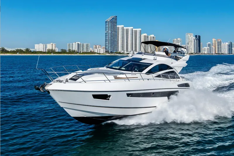 Slide: The Image of 2014 Sunseeker 68 Sport Yacht cruising near city skyline on a sunny day. - 7