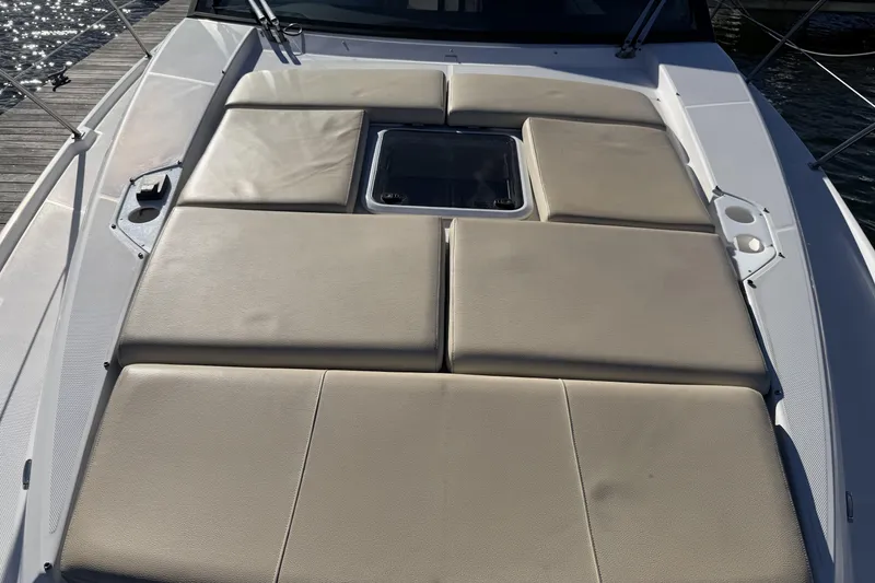 Slide: The Image of Sunpad on 2019 Regal 42 Grande Coupe yacht, featuring beige cushions and sleek design. - 11