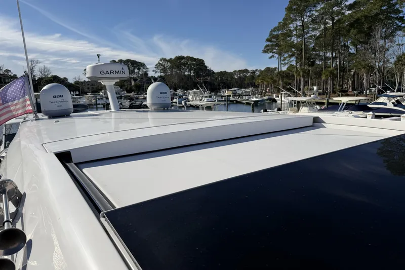 Slide: The Image of 2019 Regal 42 Grande Coupe yacht with Garmin radar, docked in a marina. - 14