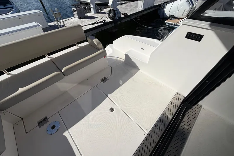 Slide: The Image of 2019 Regal 42 Grande Coupe yacht interior with seating and dock view. - 16