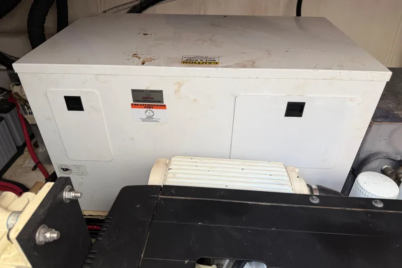 Slide: The Image of Engine compartment of a 2019 Regal 42 Grande Coupe with visible generator and components. - 19