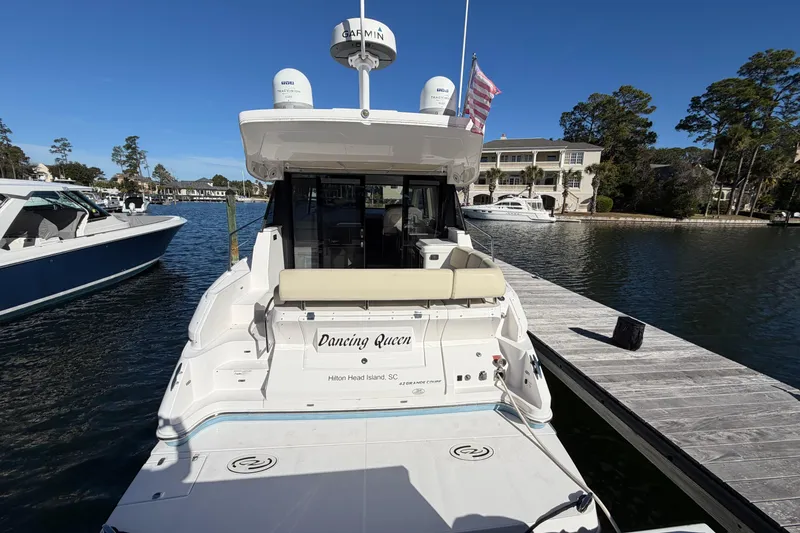 Slide: The Image of 2019 Regal 42 Grande Coupe yacht docked at Hilton Head Island marina. - 2