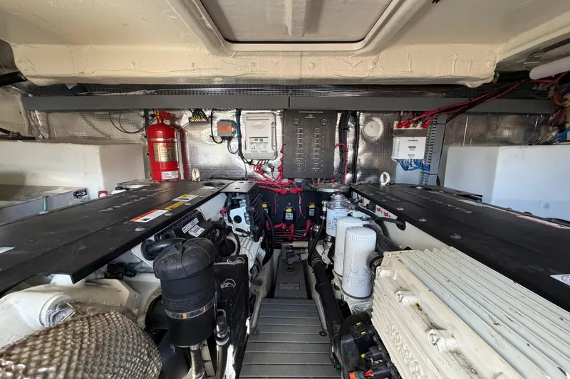 Slide: The Image of Engine room of 2019 Regal 42 Grande Coupe with visible machinery and fire extinguisher. - 20