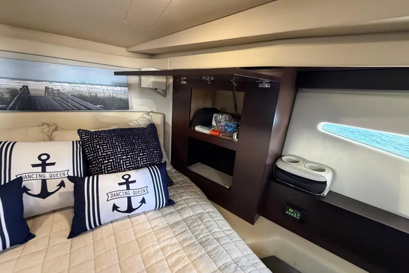Slide: The Image of Luxurious cabin interior of 2019 Regal 42 Grande Coupe yacht with nautical-themed decor. - 29