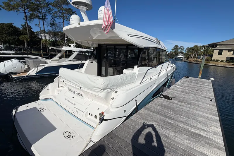 Slide: The Image of 2019 Regal 42 Grande Coupe yacht docked on a sunny day. - 3