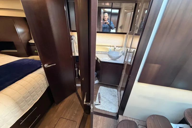 Slide: The Image of Luxurious interior of 2019 Regal 42 Grande Coupe yacht, featuring bedroom and modern bathroom. - 31