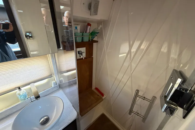Slide: The Image of Bathroom interior of 2019 Regal 42 Grande Coupe yacht, featuring sink and shower area. - 34