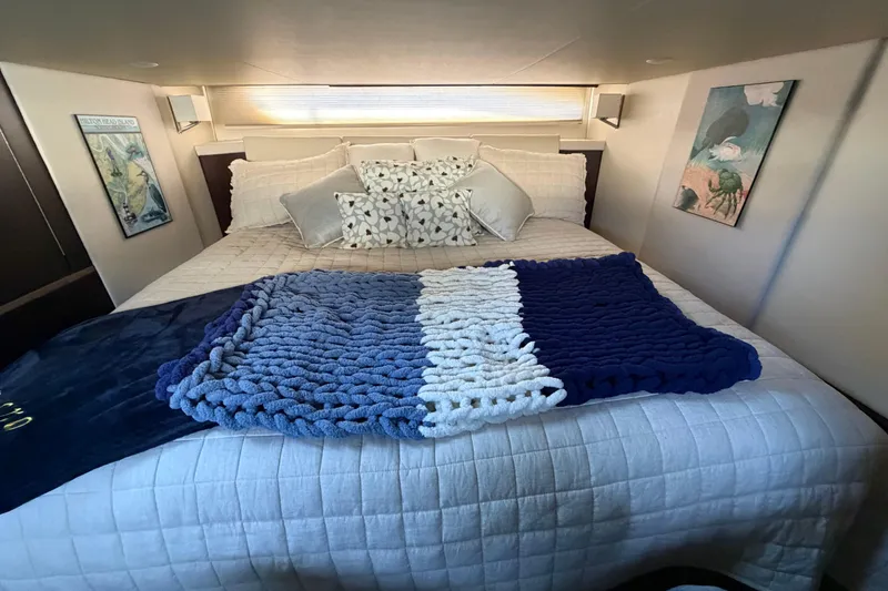 Slide: The Image of Luxurious bedroom interior of 2019 Regal 42 Grande Coupe yacht with cozy bedding. - 39