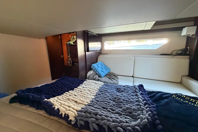 Slide: The Image of Cozy interior cabin of 2019 Regal 42 Grande Coupe with plush bedding and modern design. - 40