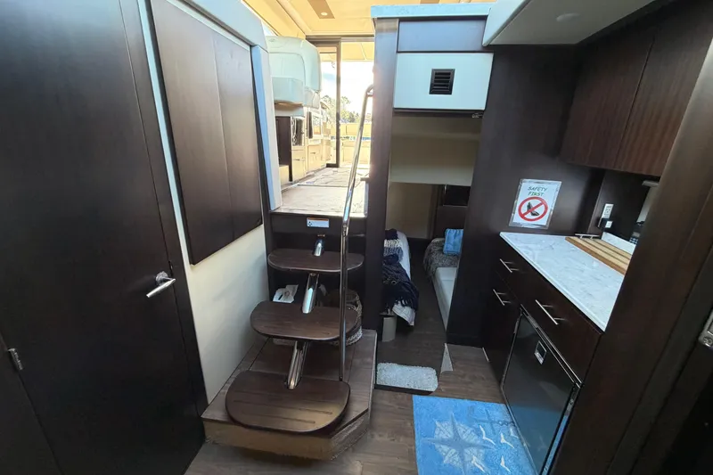 Slide: The Image of Interior of 2019 Regal 42 Grande Coupe yacht with modern kitchen and stairs. - 43