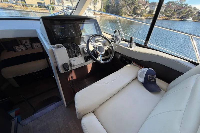 Slide: The Image of Interior of 2019 Regal 42 Grande Coupe yacht with steering wheel and navigation controls. - 44