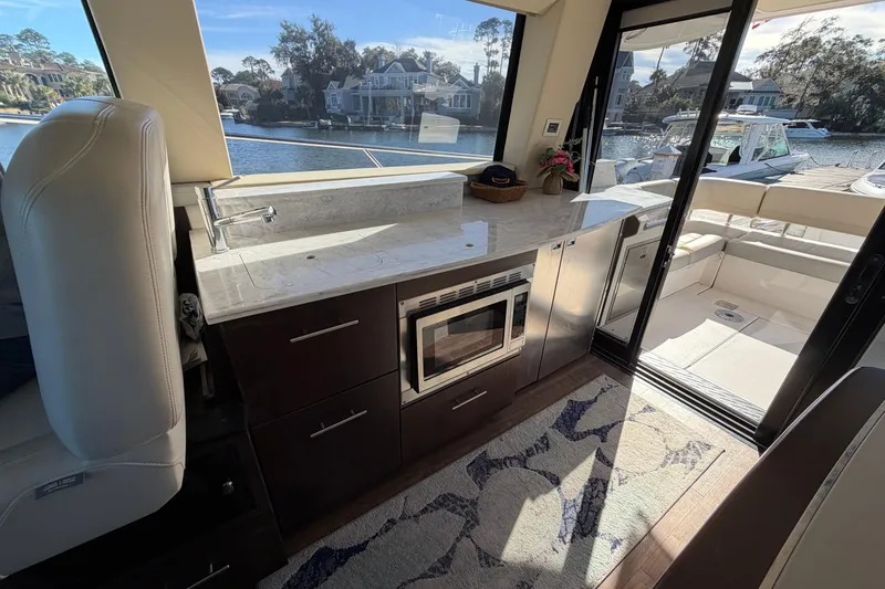 Slide: The Image of Luxurious interior of a 2019 Regal 42 Grande Coupe yacht with modern kitchen amenities. - 45