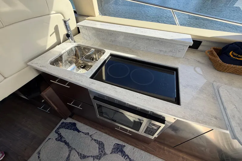 Slide: The Image of Luxurious kitchen area in 2019 Regal 42 Grande Coupe yacht with sink and stove. - 49
