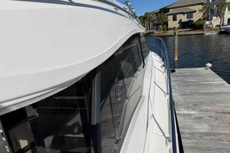Slide: The Image of 2019 Regal 42 Grande Coupe yacht docked at a marina, side view. - 5