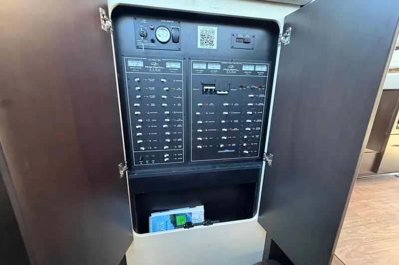 Slide: The Image of Electrical panel inside 2019 Regal 42 Grande Coupe yacht, showcasing switches and controls. - 53
