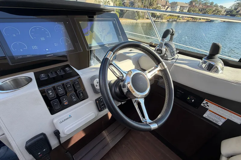 Slide: The Image of Cockpit of 2019 Regal 42 Grande Coupe with steering wheel and navigation displays. - 57