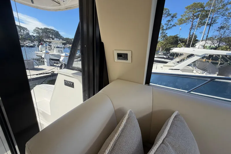 Slide: The Image of Interior view of 2019 Regal 42 Grande Coupe yacht with marina backdrop. - 59