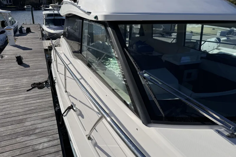 Slide: The Image of 2019 Regal 42 Grande Coupe yacht docked at marina, side view. - 6