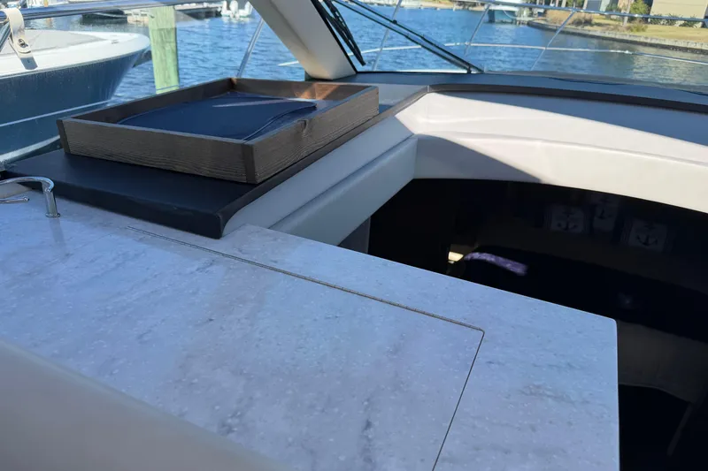 Slide: The Image of 2019 Regal 42 Grande Coupe yacht interior with marble countertop and wooden tray. - 62