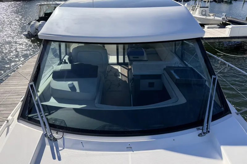 Slide: The Image of 2019 Regal 42 Grande Coupe yacht docked, showcasing sleek design and spacious interior. - 7